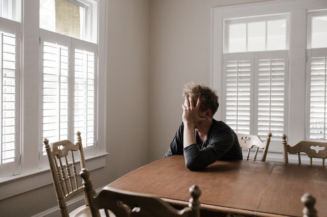 burned out man at table